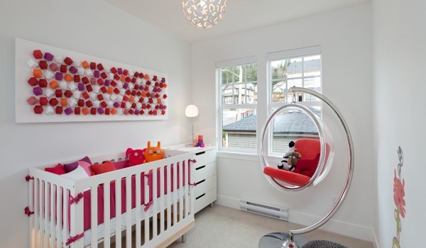 Having a new addition to the family does not have to mean sacrificing style. This nursery is modern but carefully accented with playful colors and different textures and materials to keep the attention of baby and parents alike.