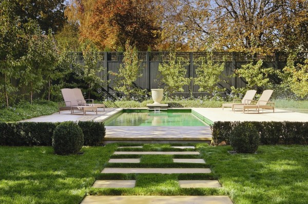 This modern take on the classic stepping stones uses parallel slabs in a repeat pattern to creep across the lush blanket of grass. Create a vista at the end of your pathway, it doesn't have to be a pool like this one, a simple focal point like a wall mounted fountain will work wonders in a smaller space.