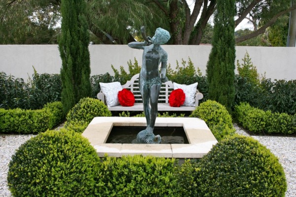 Traditional garden sculptures bring an element of aristocratic class to gentle landscaping, and don't forget to place a comfortable bench nearby where you can sit and appreciate the artwork.