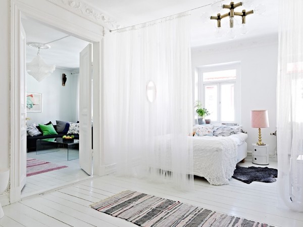 Gauzy white curtains don't do much to keep out noise, but sometimes the suggestion of division is enough to make a space more comfortable.