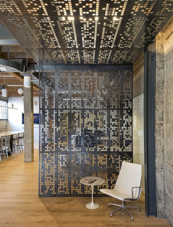 This medal room divider appears almost pixelated, letting it blend easily with the industrial design of this urban loft.