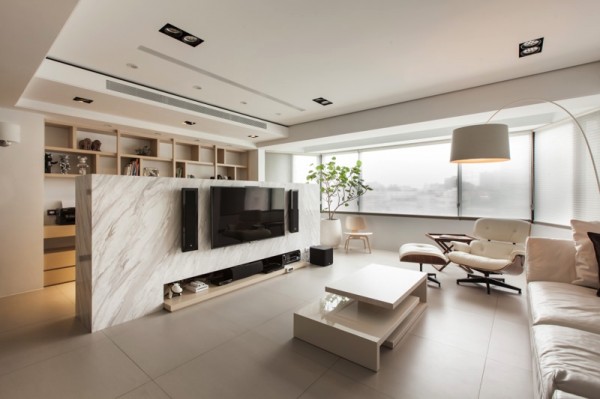 This low marble wall conceals an office space and also acts as a mount for a flatscreen.