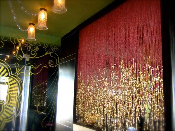 Some room dividers are more nightclub than midcentury. The gold sparkles in this handing curtain are brash and playful in a glorious middle eastern way.