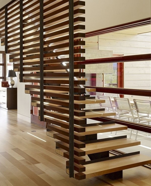 The wood slats that float up with this staircase are a beautiful design element in this wood heavy home.