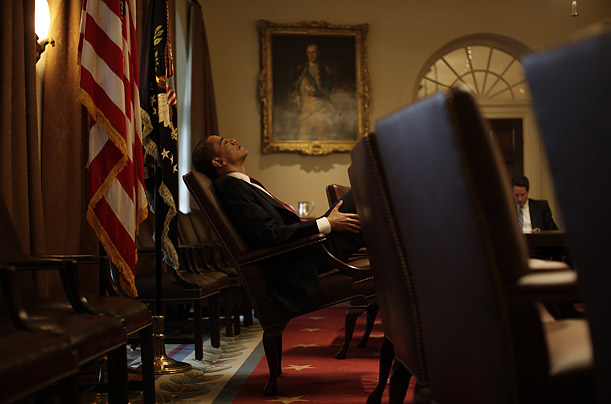 obama sitting at his chair and brooding oval office