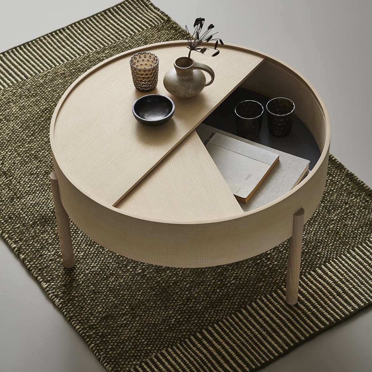 https://www.home-designing.com/wp-content/uploads/2019/07/Designer-Round-Coffee-Table-With-Storage-Unfinished-Wood-3-Legs.jpg