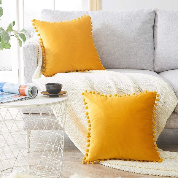 https://www.home-designing.com/wp-content/uploads/2020/09/Yellow-Decorative-Pillow-with-Pom-Poms-Square-Shape-Velvet-Fabric-600x600.jpg