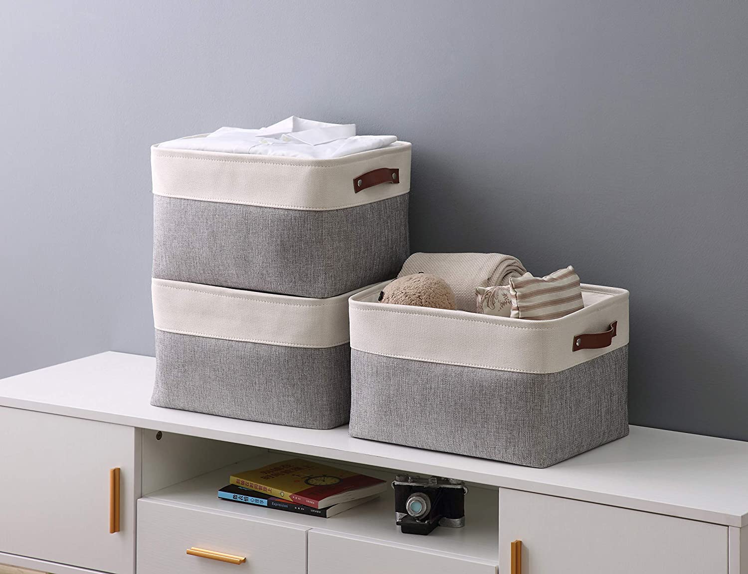 https://www.home-designing.com/wp-content/uploads/2020/10/simple-cloth-storage-bins-two-tone-cream-and-grey-leather-handles-stylish-home-organization-accessories.jpg