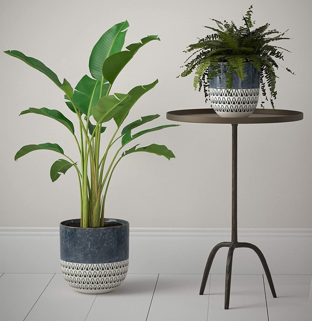 large blue and white planter with geometric tribal pattern speckled glaze 10 inches tall