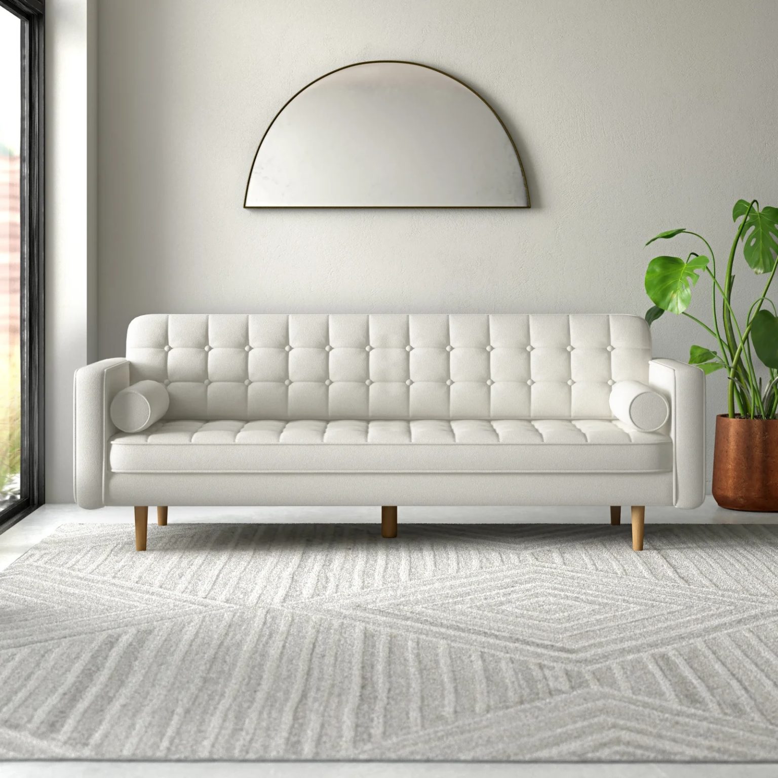 midcentury bright white sofa with bolster pillows and button tufting