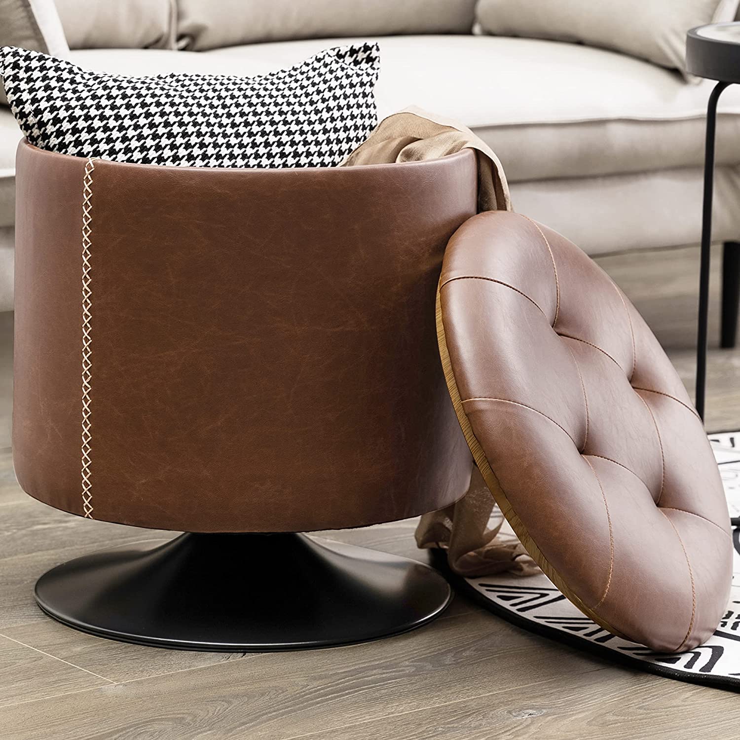 compact round leather ottoman with storage and swivel base tufted lid with contrast stitching and flared black metal foot unique living room furniture ideas vanity stool cheap