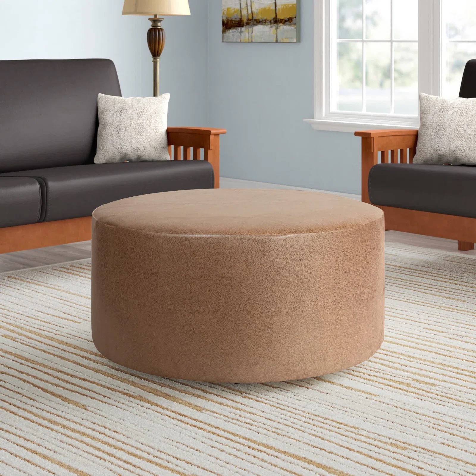 minimalist leather tan ottoman round shape simple lines straightforward rounded cocktail ottoman for living room sofa design multiple color options available footrest