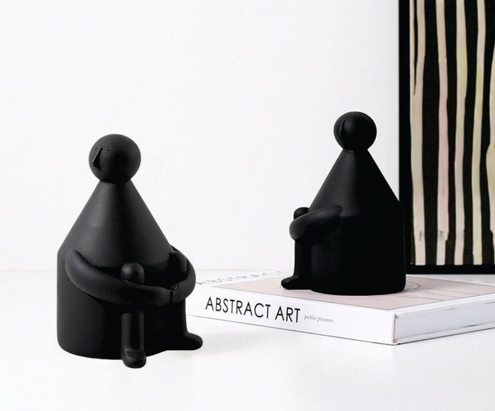 contemplative black ceramic figurine